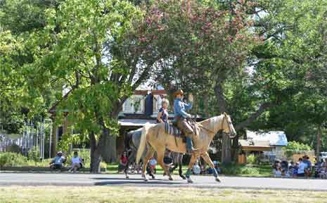 Main Street parade, man and a boy riding a horse